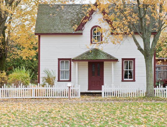 white house under maple trees